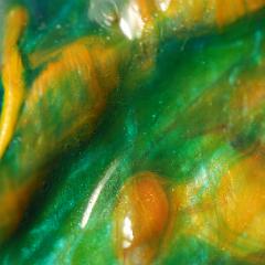 Orange green lumpy painting close-up