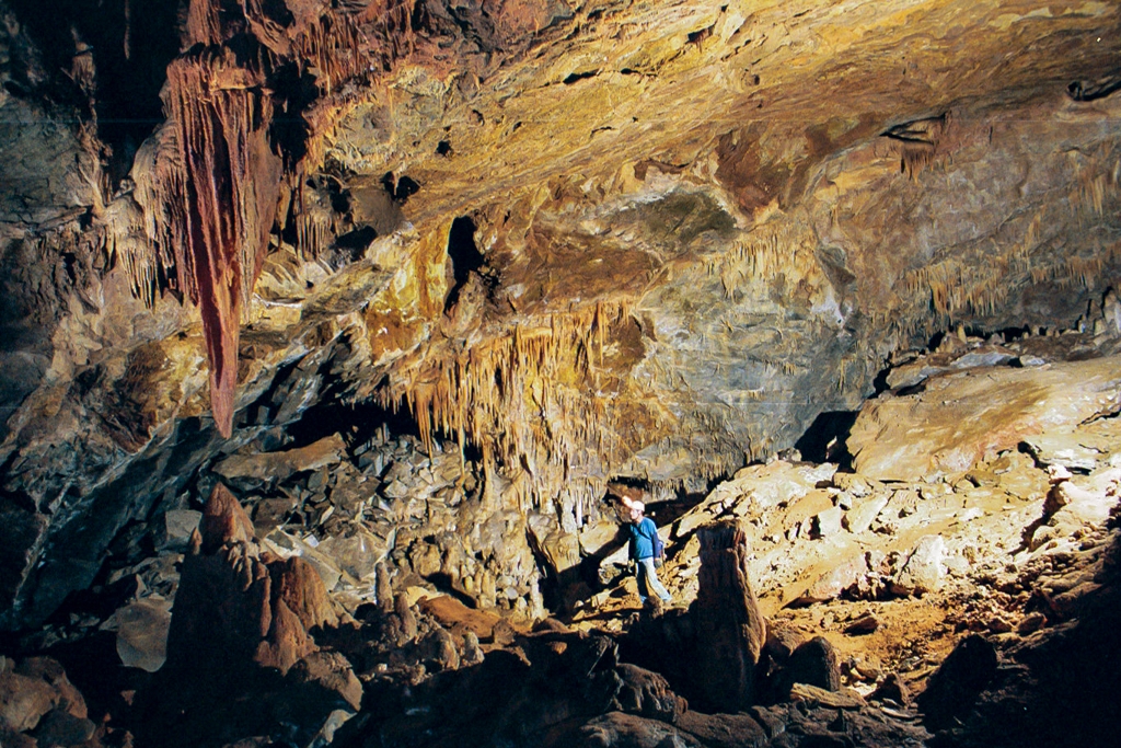 Palmers Cave, California photograph. Large room with model looking at stalactite. I sold this photo to a catalog to sell Rolex watches for auctions!