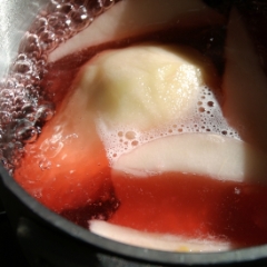 Pears simmering in wine sauce