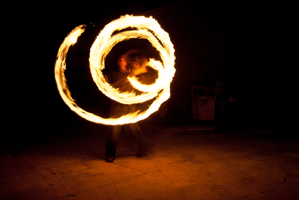 Fire Spinners photograph. Sam making a spiral with the rope dart of fire.