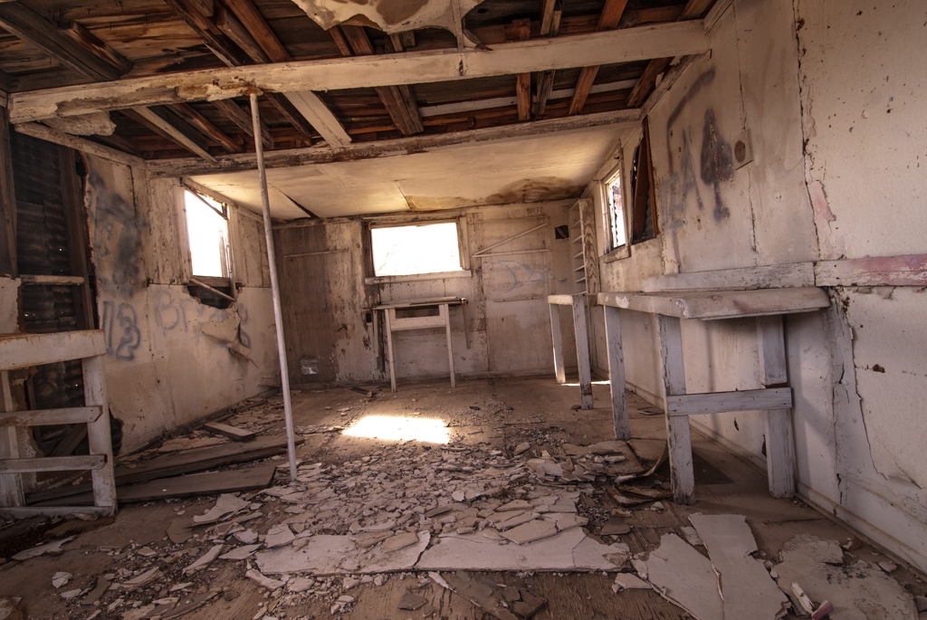Death Valley, California photograph. Interior of a crumbling, abandoned building with drywall and pieces of wood scattered all over the floor. The soft light is beautiful. 