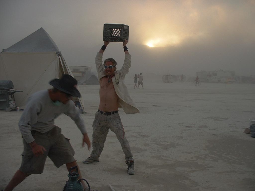 Burning Man 2003 photograph. Random seems to be aiming a crate at Andrew's head. Andrew scurries!