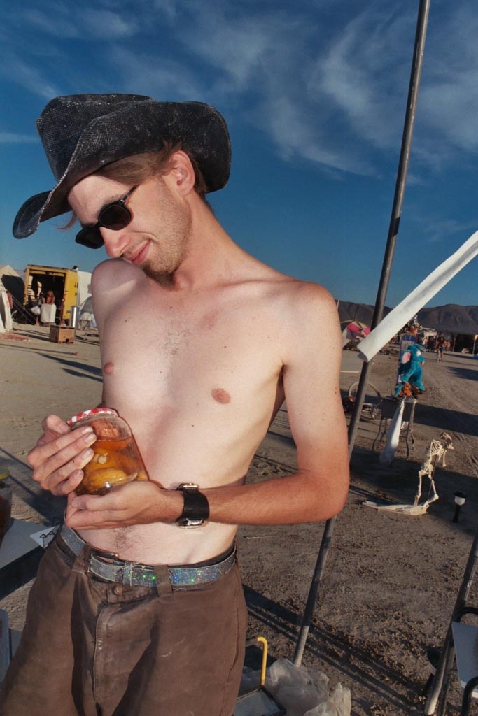 Burning Man 2003 photograph. This is my neighbor who made the dolls in vinegar jars, and other weird art. He seemed so pleased that I would like to photograph his art. It was simple, but beautiful. If you know who he is, drop me a line.