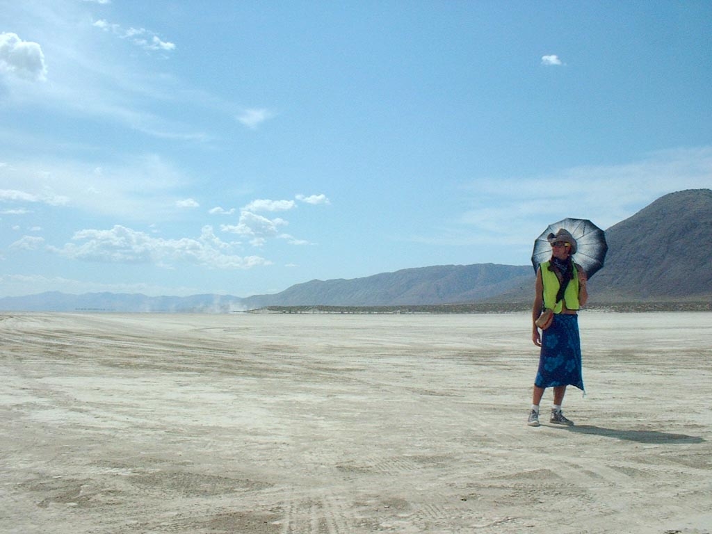 Burning Man 2003 photograph. A burner against the stark desert background. This must have been after the crowds cleared and we were all driving home.