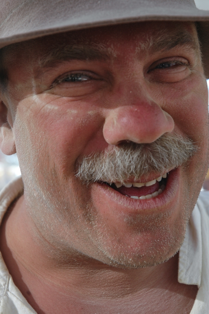Burning Man 2004 photograph. One-legged Dave, who called himself that because he was missing a foot. He made a large copper foot car in the shape of a giant foot that you could drive around on the playa. He later made me some copper art. 