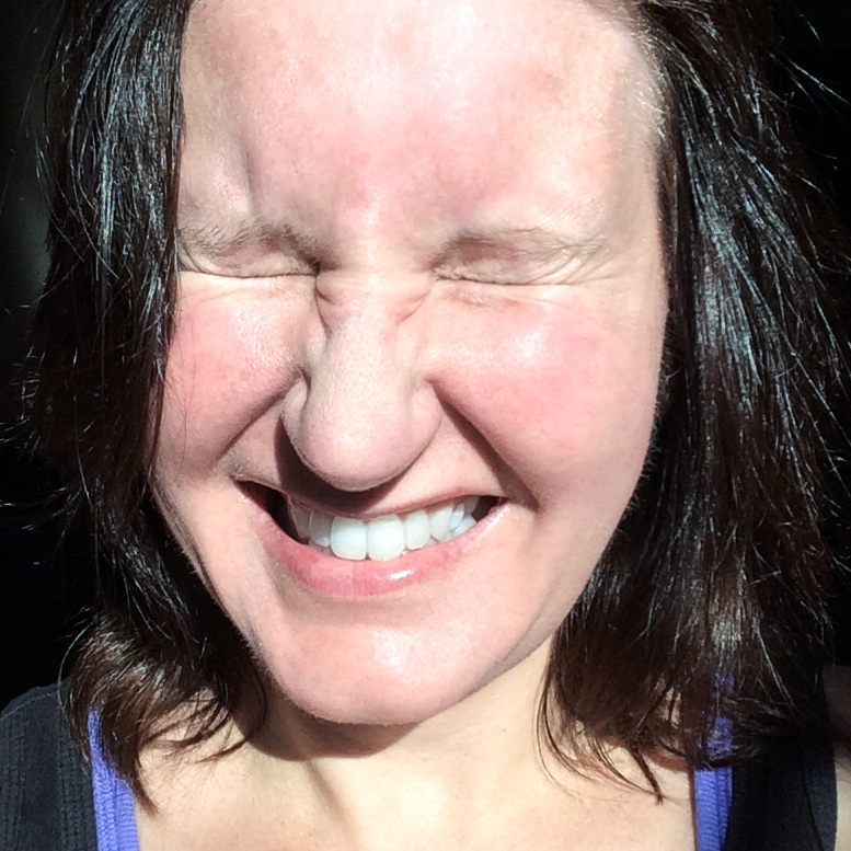 Self portrait of Kristen squinting in the sun